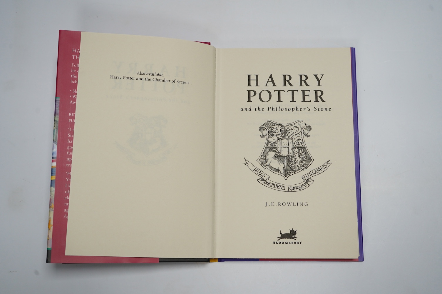 Rowling, J. K. - Harry Potter and the Philosopher's Stone. First Edition (reprinted). armorial half and title pages. publisher's coloured pictorial boards and d/wrapper. Bloomsbury, (?1999)